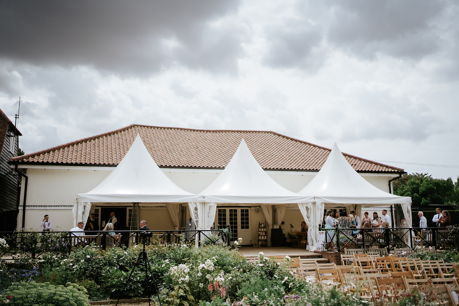 The Coach House at Marks Hall Estate wedding venue near Colchester with elegant white marquee canopy and formal gardens set up for outdoor ceremony — photographed by Lily & White