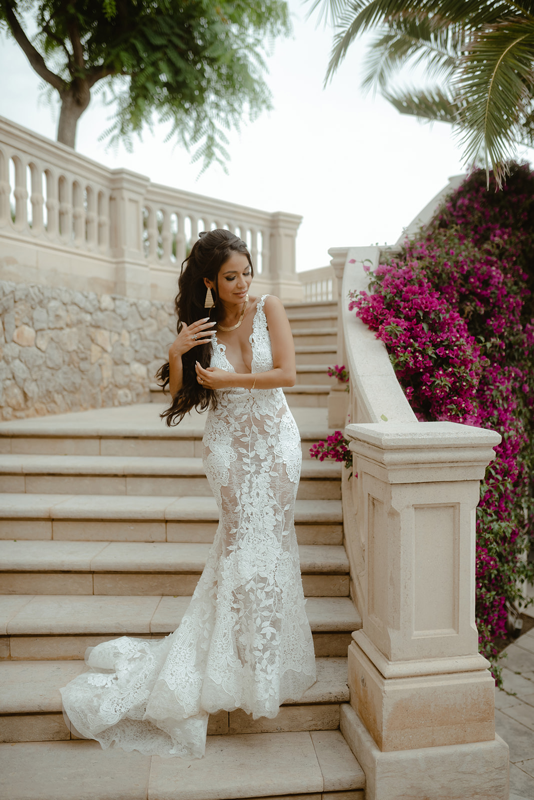 Bride on a stone staircase with bougainvillea at Xalet del Nin, near Sitges